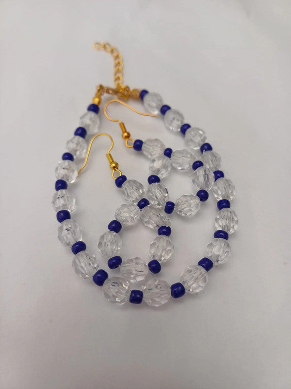 Gold hook earrings with clear faceted beads and small blue round beads, arranged in a loop pattern on a white background.