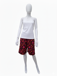 Mannequin wearing a white tank top and red floral-patterned shorts with pink and orange accents on a white background.