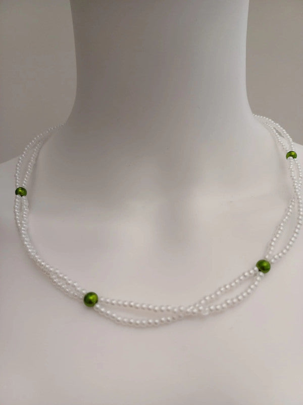 A close-up shows a mannequin’s neck adorned with the Pearl Beaded Necklace with Green Accents—three strands of white beads highlighted by bold green beads. Ideal for your ExportYourStore.com product listing.