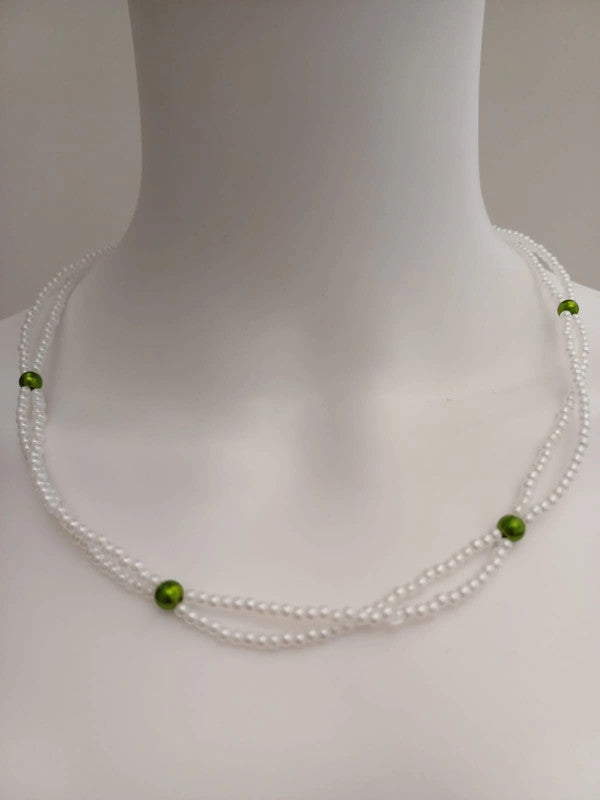 The Pearl Beaded Necklace with Green Accents features two strands of small white beads and spaced green beads, shown on a white mannequin neck—ideal for your next product listing on ExportYourStore.com.