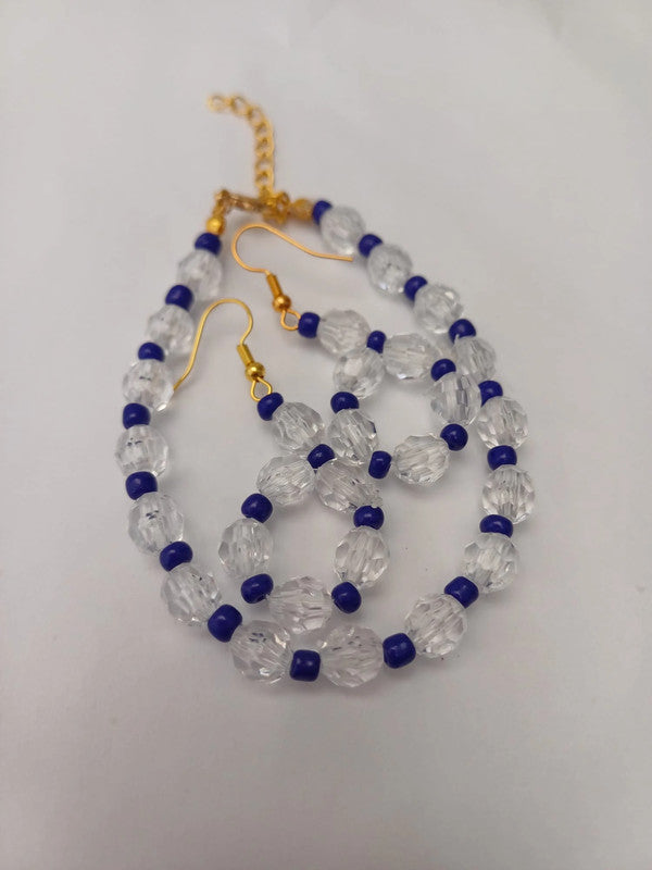 Gold hook earrings with clear faceted beads and small blue round beads, arranged in a loop.