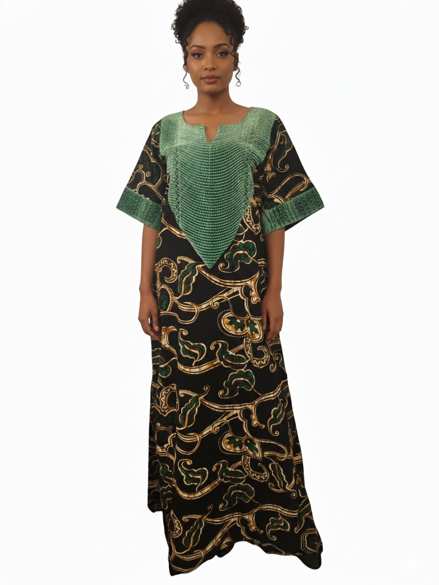 A woman models the Green & Black Regal Ankara Kaftan Dress, featuring gold patterns and a green textured top, styled as elegant African attire against a plain white background.