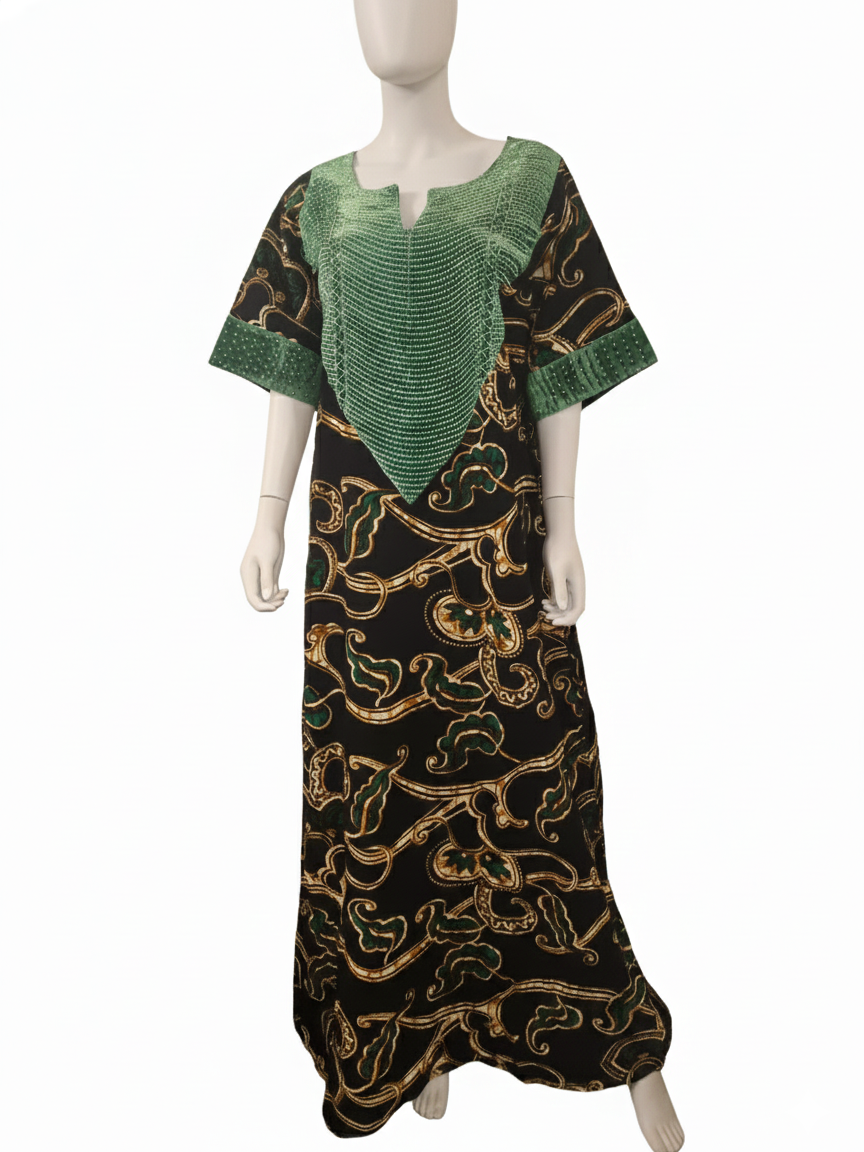 A mannequin wears the Green & Black Regal Ankara Kaftan Dress, featuring green patterned fabric on the chest and sleeves, with a black base adorned with an intricate gold and green abstract design.
